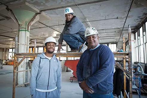 CEA construction instructor and Ma’at foreman Johnnie Comer (right), standing with Homewood natives Woody Yates (center) and Adrian Foster (left), on one of the floors they are remodeling at the 7800 Susquehanna Street warehouse renovation project. - PHOTO BY HEATHER MULL