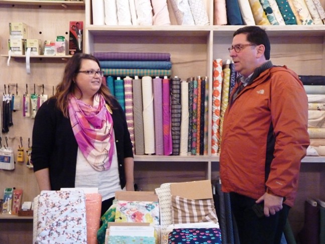 Michelle Lancet, co-owner of the fabric store Spool, in Allentown, welcomes Pittsburgh Mayor Bill Peduto for a visit on Small Business Saturday. - PHOTO BY ASHLEY MURRAY