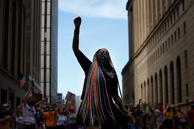 Toy Slaughter raises a fist during a Black Lives Matter march in Downtown Pittsburgh on Tue., June 16, 2020. - CP PHOTO: JARED WICKERHAM