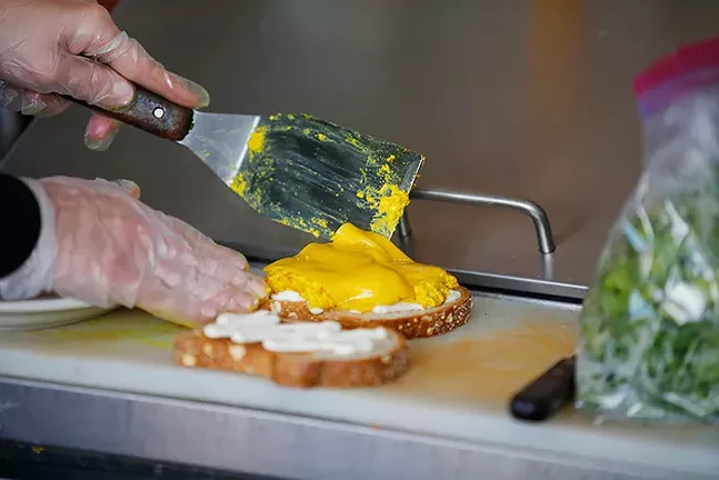 A breakfast sandwich made with a tofu scramble, vegan cheese, veganaise, arugula, and tomato on wheat bread from Kaibur Coffee & Cafe - CP PHOTO: JARED WICKERHAM