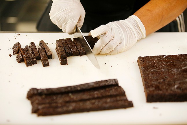 Oliver Pinder, owner and chef at Wild Rise Bakery, prepares gluten-free brownies for Millie’s Ice Cream, which will end up in their “Blackout Brownie,” a collaboration with Pittsburgh artist Cue Perry. - CP PHOTO: JARED WICKERHAM