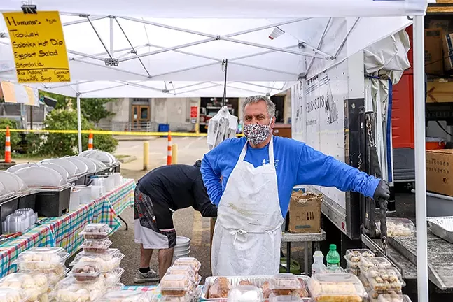 Vasillis Kontoulis, owner of Little Athens Express hosts his booth at a farmers market in East Liberty May 10 - CP PHOTO: KAYCEE ORWIG