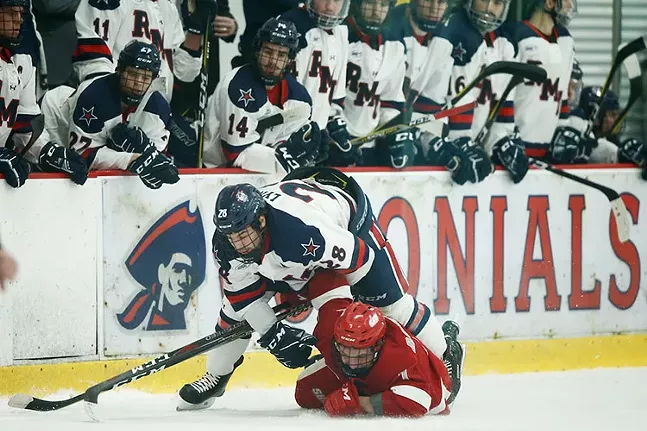 Luke Lynch of the Robert Morris Colonials lands on top of Ruslan Rakhmatov of the Sacred Heart Pioneers during a Robert Morris University and Sacred Heart University NCAA hockey game on Fri., Feb.1, 2019 - CP PHOTO: JARED WICKERHAM