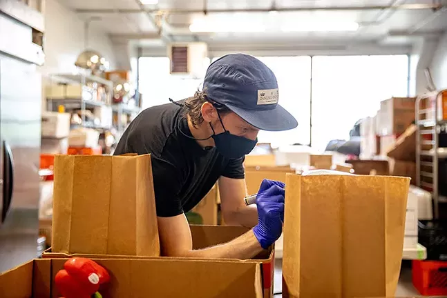 Pittsburgh Restaurant Workers Aid Volunteer, David Bigbee puts together care packages for restaurant workers. - CP PHOTO: KAYCEE ORWIG