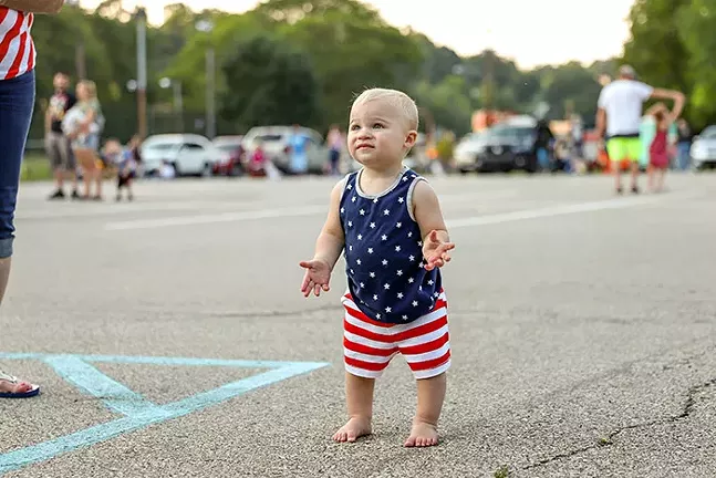 A toddler dances to the music in the Dormont Pool Parking Lot before during the Dormont Day Fourth of July celebration. - CP PHOTO: KAYCEE ORWIG