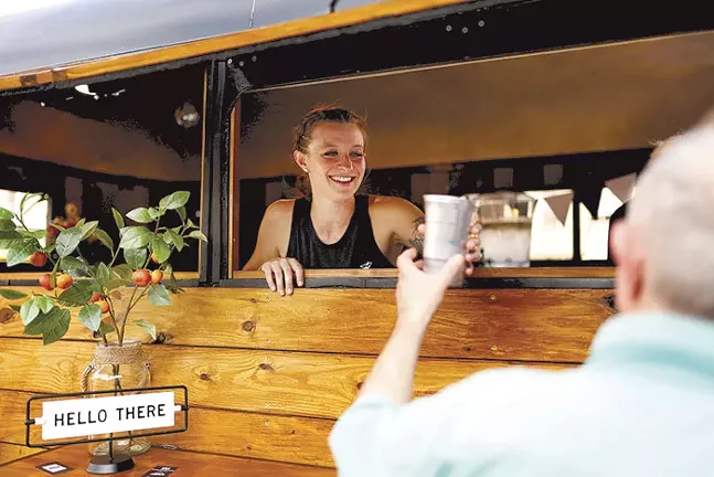 Co-owner Katie Sirianni serves a customer during the grand opening of Sips Mobile Bar in Dormont on Fri., July 23. - CP PHOTO: JARED WICKERHAM