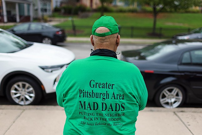 A member of Greater Pittsburgh Area MAD DADS stands in front of the East Hills Community Center on Sat., Oct. 9. - PHOTO: QUINN GLABICKI/PUBLICSOURCE