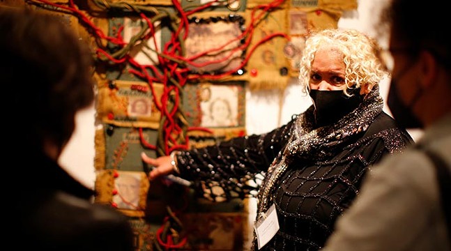 Artist LaVerne Kemp poses with her fiber tree artwork at the Women of Visions show on opening night inside the Frick Fine Arts Building in Oakland. - CP PHOTO: JARED WICKERHAM