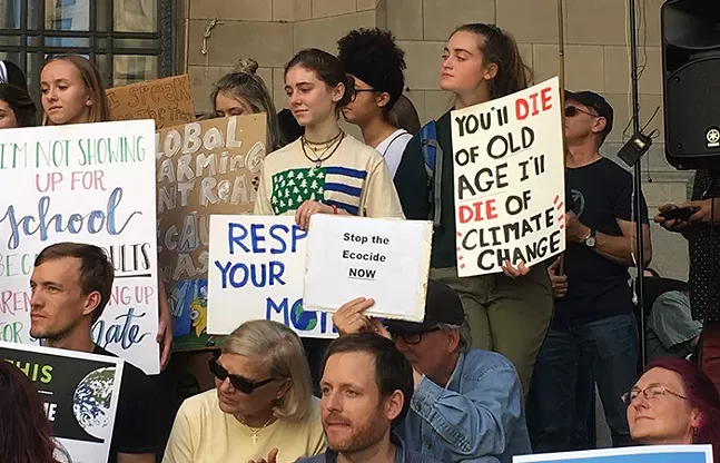 Demonstrators hold signs at the Global Climate Strike in Downtown Pittsburgh, September 2019 - CP PHOTO: AMANDA WALTZ