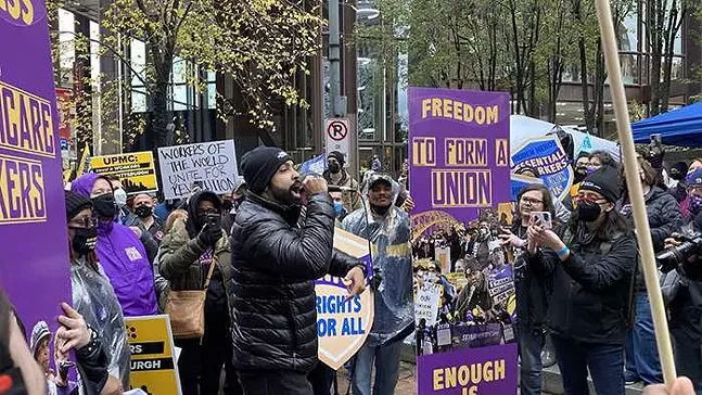 Local rapper and activist Jasiri X entertains the crowd of protesting UPMC workers on Nov. 18 in Downtown Pittsburgh - CP PHOTO: JASON PHOX