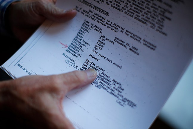 Author David Garrow shows documents related to Malcolm X inside of his Squirrel Hill home. - CP PHOTO: JARED WICKERHAM