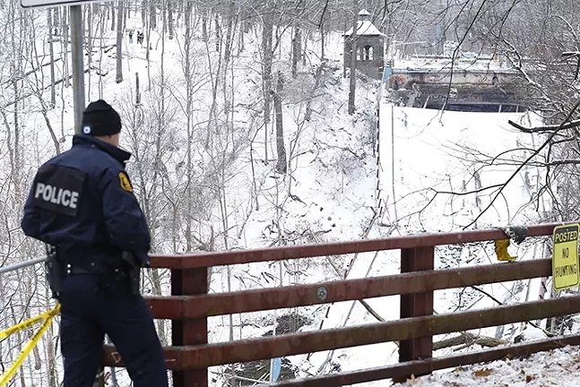 Pittsburgh Police overlook the collapsed Fern Hollow Bridge on Fri., Jan. 28, 2021. - CP PHOTO: JARED WICKERHAM