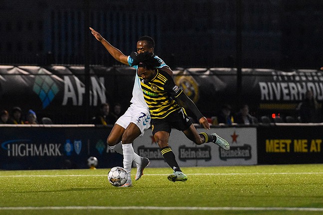 Pittsburgh Riverhounds forward Alex Dixon (7) battles for possession of the ball against Hartford Athletic. - CP PHOTO: PAM SMITH