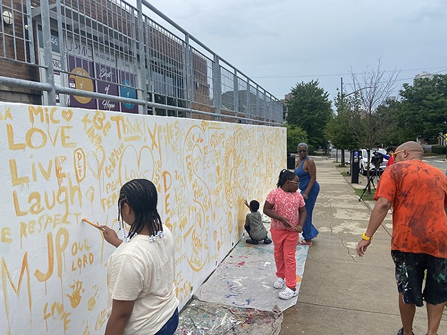 Artists and community volunteers begin painting the largest mural in town (3)