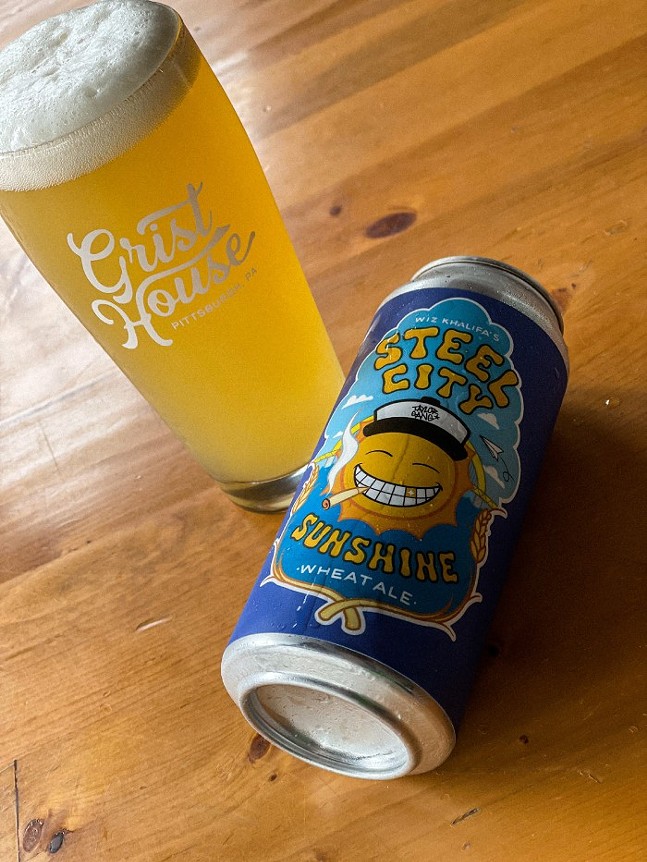 A can of beer with "Steel City Sunshine" written on the label above a smiling illustration of a sun sits next to a glass of beer