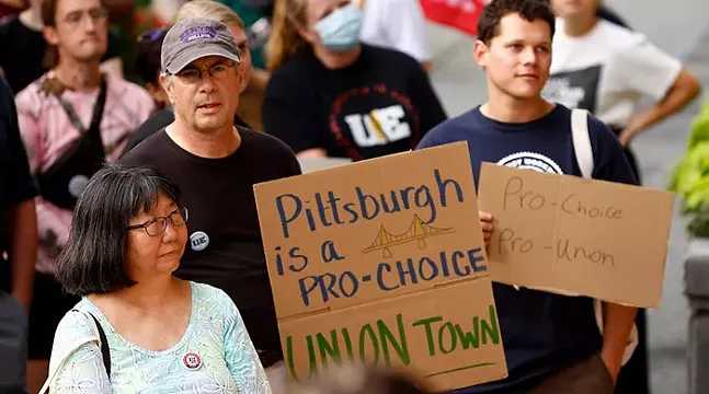 Crowd of protesters holding signs including "Pittsburgh is a pro-choice union town" and "pro-choice pro-union"