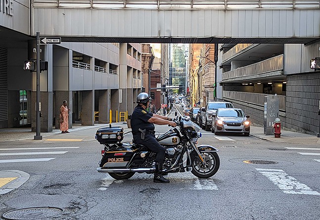 Pittsburgh Police officer on a motorcycle blocking a Downtown street