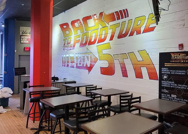 The words "Back To The Foodture" are splashed across a wall in a bar and restaurant.