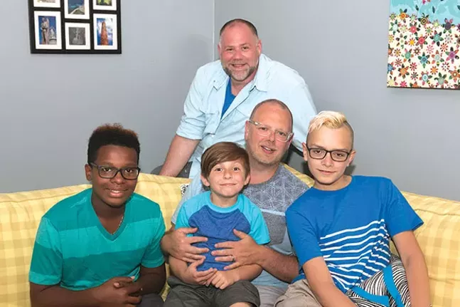 Sean O’Donnell (behind sofa) and his husband Todd Collar (sitting) with their adopted sons A’Sean (left), Elijah (center) and Chris (right) at their home on the North Side - CP PHOTO BY JOHN COLOMBO