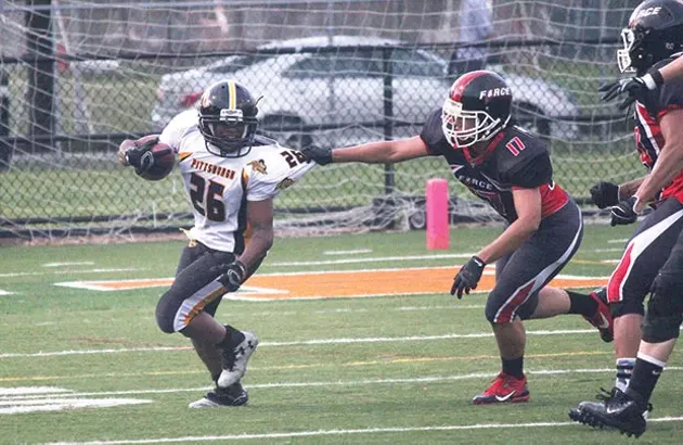 Pittsburgh Passion running back Gabrielle O’Neil gets snagged by Chicago defensive back Nicole Matheson. - CP PHOTO BY BEN POPE