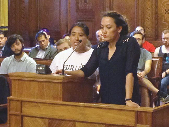 Brenda Solkez (right) translating for an undocumented immigrant speaking at a July 12 public hearing - CP PHOTO BY RYAN DETO