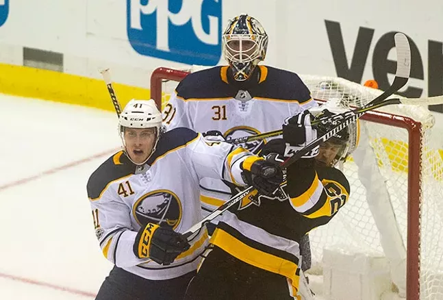 Carl Hagelin battles with Buffalo Sabres Justin Falk in front of the Sabres net. - CP PHOTO BY VINCENT PUGLIESE