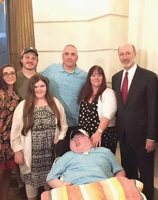 Ryan Briggs and his family pose for a photo with Gov. Tom Wolf the day he signed the medical-marijuana bill into law.