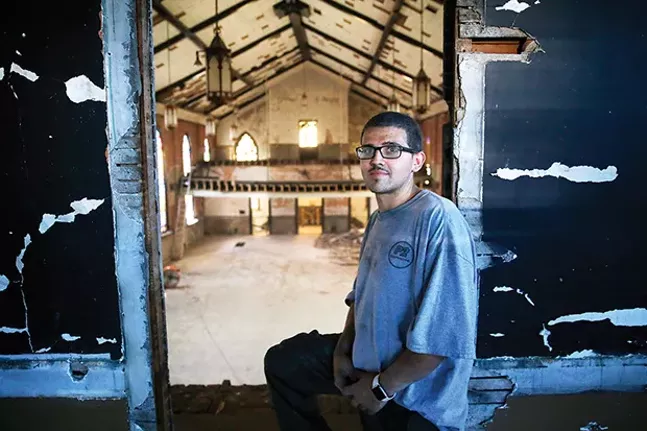 Rich Weber, part of the demo crew for P2 Construction, stands above the second floor at St. Peter's.