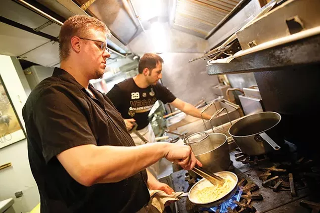 Chef John Gault prepares fettuccini Alfredo at Legends of the North Shore. - CP PHOTO BY JARED WICKERHAM