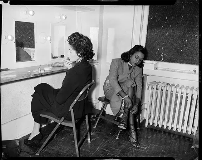 A history of fashion: Photographer Charles “Teenie” Harris’ 1954 photograph of Barbara Lee and Delilah Hargrove, cast members of play “Take a Giant Step,” in dressing room of Pittsburgh Playhouse - PHOTO COURTESY OF CARNEGIE MUSEUM OF ART, HEINZ FAMILY FUND