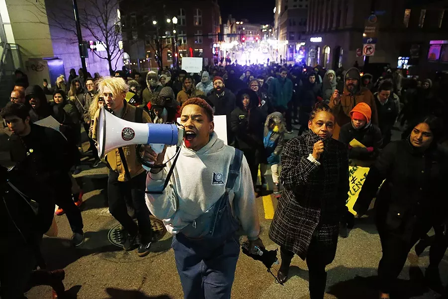 Christian Carter leads the protesters through East Liberty - CP PHOTO: JARED WICKERHAM