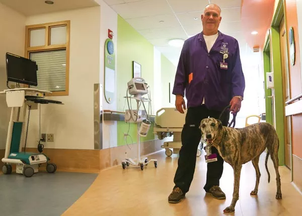 Pet therapy: David Anderson and Lulu visit patients at Children's Hospital - PHOTO BY MIKE SCHWARZ