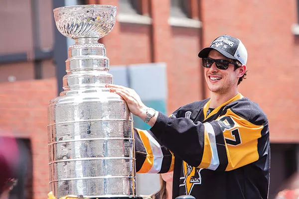 Sidney Crosby hoisted the cup in the Penguins Stanley Cup victory parade in Downtown Pittsburgh on June 15. - CP PHOTO BY LUKE THOR TRAVIS