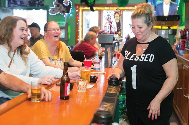 Wendy Yurok shares a laugh with customers at Kelly’s Korner Bar. - CP PHOTO BY JOHN COLOMBO