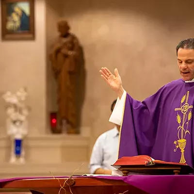 Father Tom Burke leads mass at St. Bede of Saint Mary Magdalene Parish.