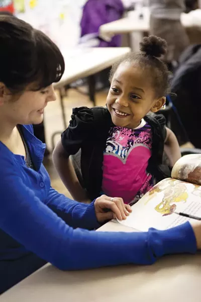 Volunteer tutor Karryn Lintelman reads The Tortoise and The Hare to Faith, age 5. - PHOTO BY HEATHER MULL