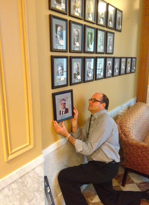 Keith Lachowicz, public arts collection manager at the Regional Arts & Culture Council, hangs up Mayor Sam Adams offiicial portrait.