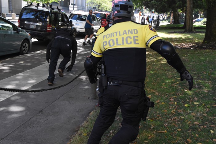 Police unsuccessfully chase a guy in black bloc