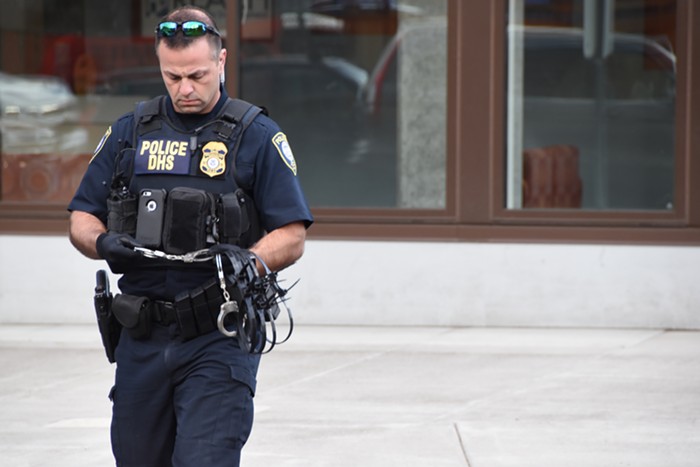 A federal cop prepares to arrest people