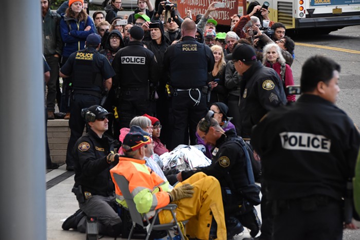 Beginning the process of detaching and arresting the linked-up protesters