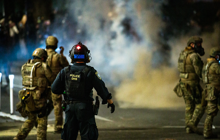 Portland Police work in concert with federal officers to tear gas and disperse protesters, Friday July 17.