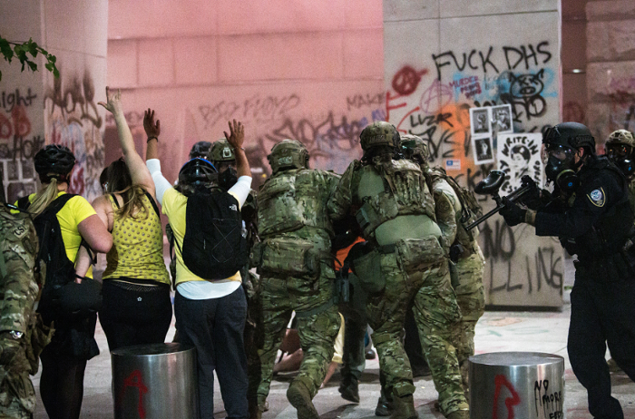 DHS officers arrest a member of the Wall of Moms protest group on July 20.