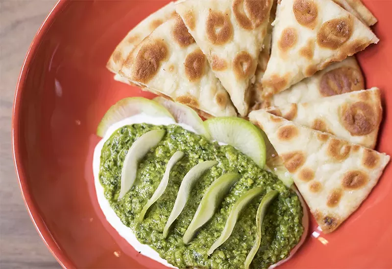 The pistachio dip is served atop goat cheese with toasted pita and radishes. - MABEL SUEN
