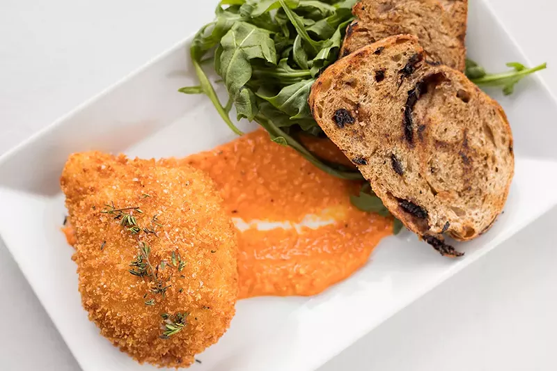 Burrata is breaded and fried and served over romesco sauce. - MABEL SUEN