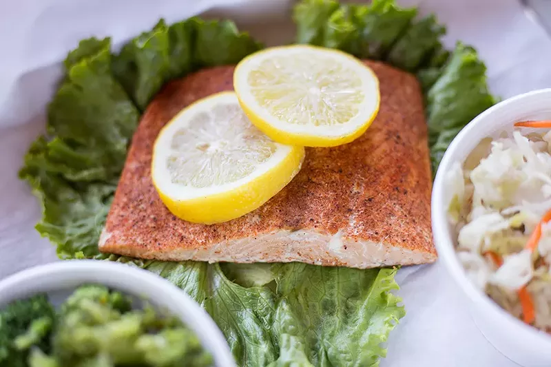The healthy portion of the menu includes a salmon entree, broccoli and "macro friendly slaw." - MABEL SUEN