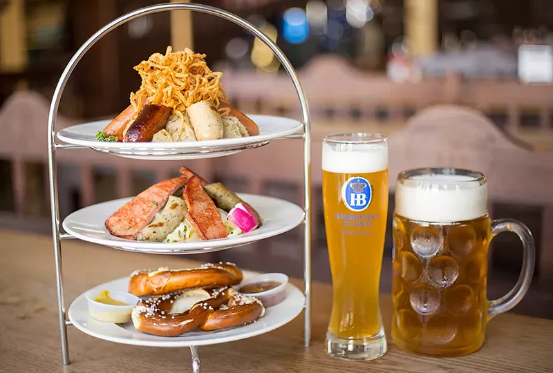 The sausage tower offers six sausages, two small pretzels, sauerkraut, German potato salad, two mustards and crispy fried onions. - MABEL SUEN