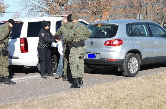 St. Louis County police arrest a protester in front of Monsanto headquarters in January.