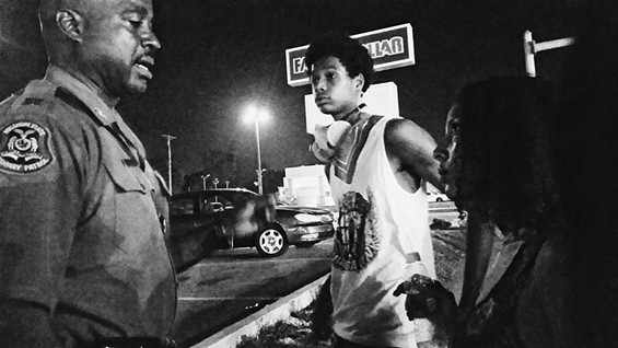 Col&oacute;n and a member of the Lost Voices talk to Captain Ron Johnson during the Ferguson protests. - RASHIDA KHANBEY