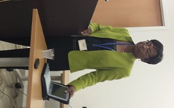 Director Dolores Gunn, of the St. Louis Health Department, with one of the laptops supplied by Gateway Technical Solutions.