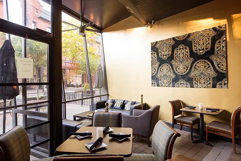 The restaurant includes a lounge and a spacious patio with sidewalk seating. - MABEL SUEN